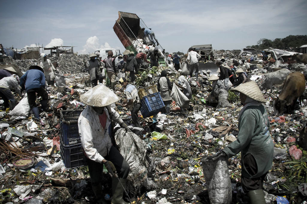 Intrepid heroes of recycling fighting for survive. Makkasar dump. Indonesia.